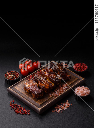 Grilled or bbq pork ribs with sauce, a food prepared for dinner. Grilled ribs 135760417