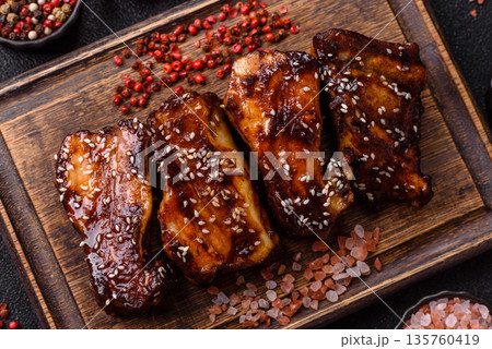Grilled or bbq pork ribs with sauce, a food prepared for dinner. Grilled ribs Grilled or bbq pork ribs with sauce, a food prepared for dinner. Grilled ribs 135760419