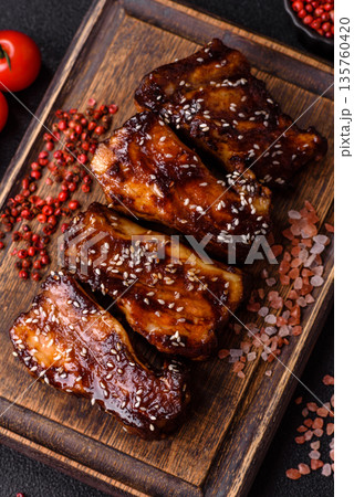 Grilled or bbq pork ribs with sauce, a food prepared for dinner. Grilled ribs Grilled or bbq pork ribs with sauce, a food prepared for dinner. Grilled ribs 135760420