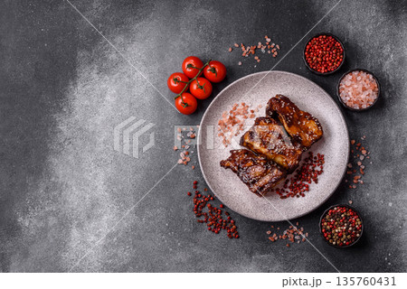 Grilled or bbq pork ribs with sauce, a food prepared for dinner. Grilled ribs 135760431