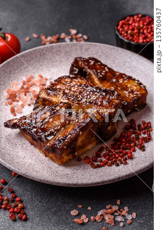 Grilled or bbq pork ribs with sauce, a food prepared for dinner. Grilled ribs 135760437