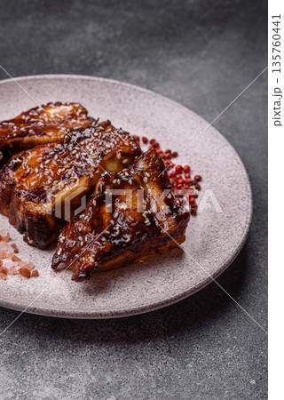 Grilled or bbq pork ribs with sauce, a food prepared for dinner. Grilled ribs Grilled or bbq pork ribs with sauce, a food prepared for dinner. Grilled ribs 135760441