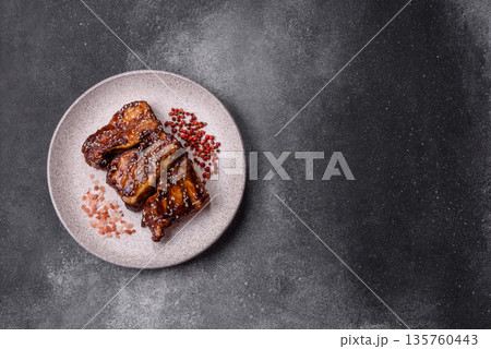 Grilled or bbq pork ribs with sauce, a food prepared for dinner. Grilled ribs Grilled or bbq pork ribs with sauce, a food prepared for dinner. Grilled ribs 135760443