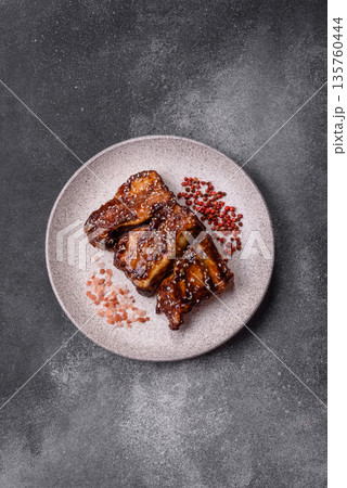 Grilled or bbq pork ribs with sauce, a food prepared for dinner. Grilled ribs Grilled or bbq pork ribs with sauce, a food prepared for dinner. Grilled ribs 135760444
