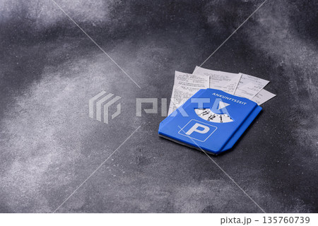 A parking disc, permit, or ticket for measuring time and paying municipal services. A parking disc 135760739
