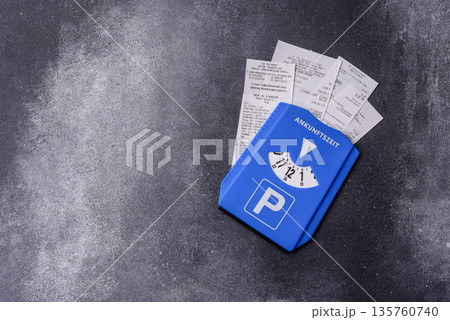 A parking disc, permit, or ticket for measuring time and paying municipal services. A parking disc 135760740