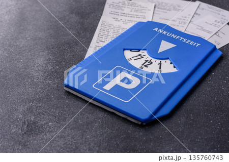 A parking disc, permit, or ticket for measuring time and paying municipal services. A parking disc A parking disc, permit, or ticket for measuring time and paying municipal services. A parking disc 135760743