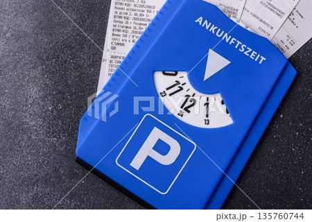 A parking disc, permit, or ticket for measuring time and paying municipal services. A parking disc A parking disc, permit, or ticket for measuring time and paying municipal services. A parking disc 135760744