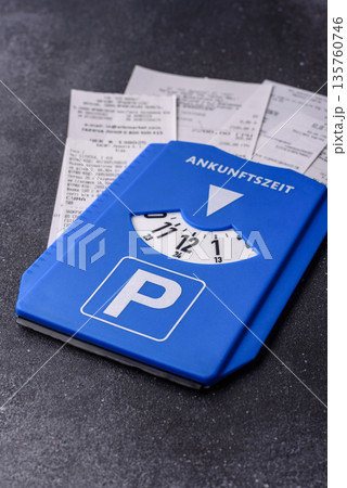 A parking disc, permit, or ticket for measuring time and paying municipal services. A parking disc A parking disc, permit, or ticket for measuring time and paying municipal services. A parking disc 135760746