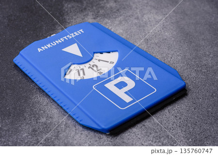 A parking disc, permit, or ticket for measuring time and paying municipal services. A parking disc A parking disc, permit, or ticket for measuring time and paying municipal services. A parking disc 135760747