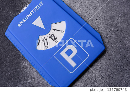 A parking disc, permit, or ticket for measuring time and paying municipal services. A parking disc 135760748
