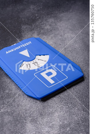A parking disc, permit, or ticket for measuring time and paying municipal services. A parking disc 135760750