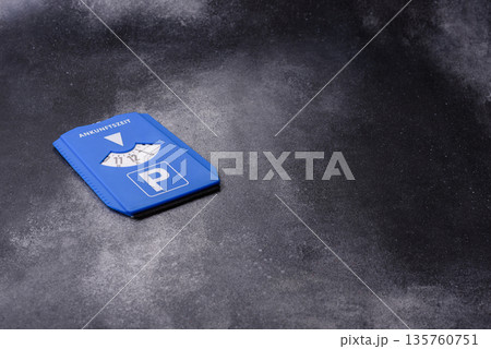 A parking disc, permit, or ticket for measuring time and paying municipal services. A parking disc 135760751