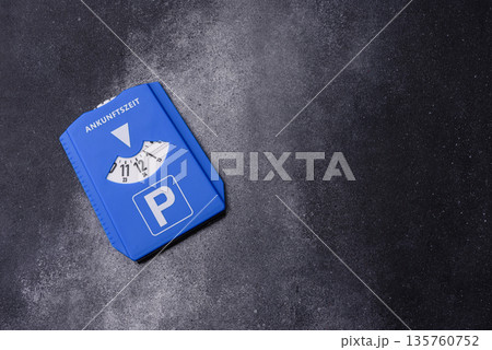 A parking disc, permit, or ticket for measuring time and paying municipal services. A parking disc 135760752