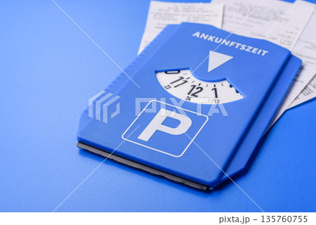 A parking disc, permit, or ticket for measuring time and paying municipal services. A parking disc 135760755