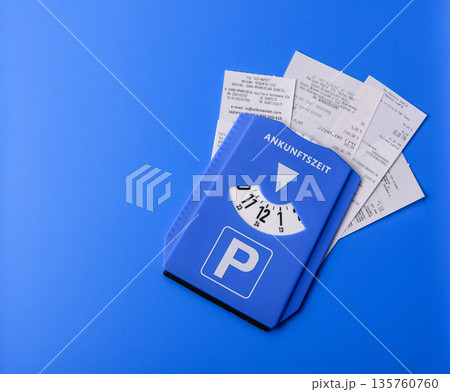 A parking disc, permit, or ticket for measuring time and paying municipal services. A parking disc A parking disc, permit, or ticket for measuring time and paying municipal services. A parking disc 135760760