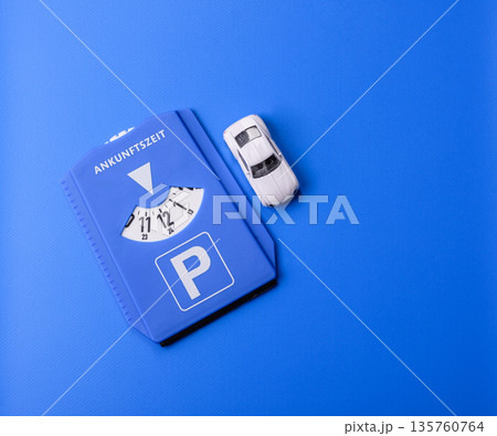 A parking disc, permit, or ticket for measuring time and paying municipal services. A parking disc 135760764