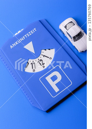 A parking disc, permit, or ticket for measuring time and paying municipal services. A parking disc 135760769