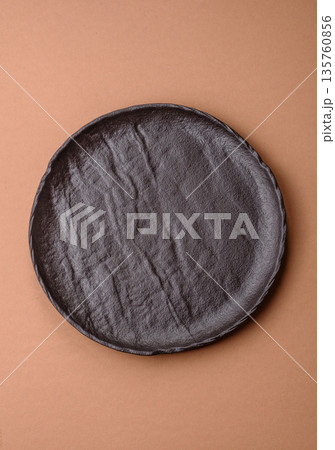 An empty round ceramic plate on a table, kitchenware. An empty plate 135760856
