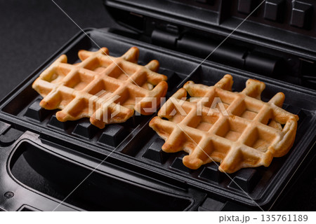Belgian waffles, a healthy sweet breakfast dessert, food background. Belgian waffles 135761189