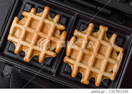 Belgian waffles, a healthy sweet breakfast dessert, food background. Belgian waffles Belgian waffles, a healthy sweet breakfast dessert, food background. Belgian waffles 135761191