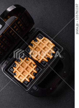 Belgian waffles, a healthy sweet breakfast dessert, food background. Belgian waffles 135761197