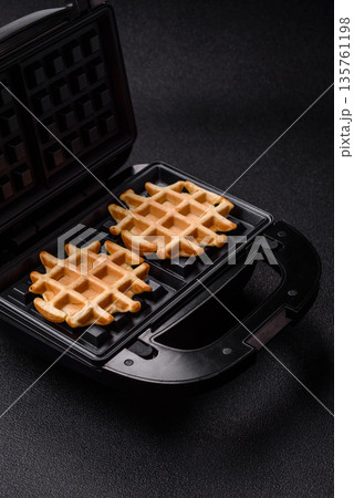 Belgian waffles, a healthy sweet breakfast dessert, food background. Belgian waffles Belgian waffles, a healthy sweet breakfast dessert, food background. Belgian waffles 135761198