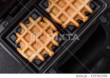 Belgian waffles, a healthy sweet breakfast dessert, food background. Belgian waffles Belgian waffles, a healthy sweet breakfast dessert, food background. Belgian waffles 135761200