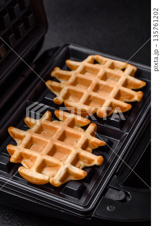 Belgian waffles, a healthy sweet breakfast dessert, food background. Belgian waffles Belgian waffles, a healthy sweet breakfast dessert, food background. Belgian waffles 135761202