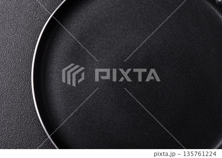 An empty black metal frying pan, kitchen utensils for cooking. An empty frying pan 135761224