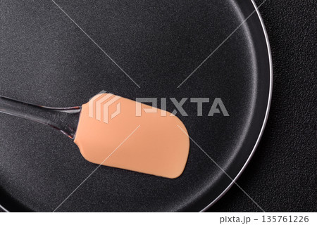 An empty black metal frying pan, kitchen utensils for cooking. An empty frying pan An empty black metal frying pan, kitchen utensils for cooking. An empty frying pan 135761226