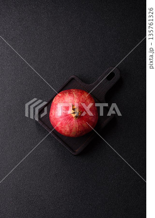 A juicy, ripe, whole red pomegranate as a source of beneficial nutrients. A whole red pomegranate A juicy, ripe, whole red pomegranate as a source of beneficial nutrients. A whole red pomegranate 135761326