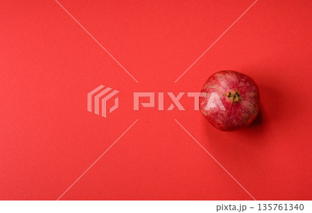 A juicy, ripe, whole red pomegranate as a source of beneficial nutrients. A whole red pomegranate A juicy, ripe, whole red pomegranate as a source of beneficial nutrients. A whole red pomegranate 135761340