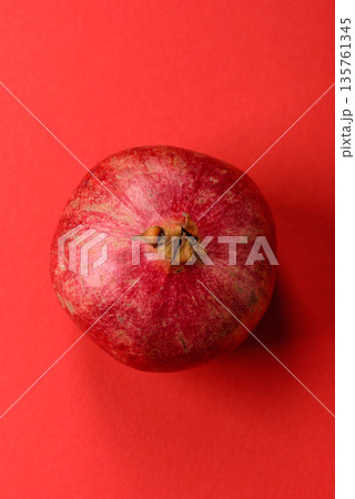 A juicy, ripe, whole red pomegranate as a source of beneficial nutrients. A whole red pomegranate A juicy, ripe, whole red pomegranate as a source of beneficial nutrients. A whole red pomegranate 135761345