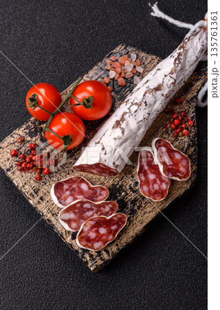 Dry Spanish salami sausage fuet as a snack for the dinner table. Fuet sausage Dry Spanish salami sausage fuet as a snack for the dinner table. Fuet sausage 135761361