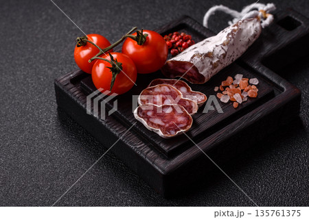 Dry Spanish salami sausage fuet as a snack for the dinner table. Fuet sausage Dry Spanish salami sausage fuet as a snack for the dinner table. Fuet sausage 135761375
