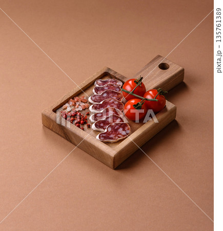 Dry Spanish salami sausage fuet as a snack for the dinner table. Fuet sausage 135761389