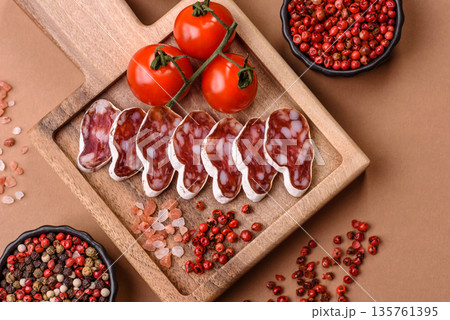 Dry Spanish salami sausage fuet as a snack for the dinner table. Fuet sausage Dry Spanish salami sausage fuet as a snack for the dinner table. Fuet sausage 135761395