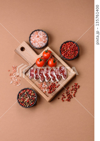 Dry Spanish salami sausage fuet as a snack for the dinner table. Fuet sausage Dry Spanish salami sausage fuet as a snack for the dinner table. Fuet sausage 135761400