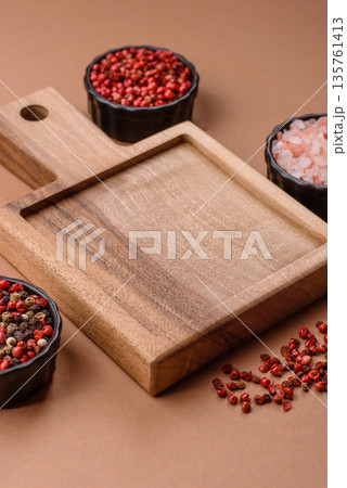 Wood, a wooden empty cutting board on a dark kitchen table. Wooden cutting board Wood, a wooden empty cutting board on a dark kitchen table. Wooden cutting board 135761413