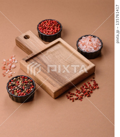 Wood, a wooden empty cutting board on a dark kitchen table. Wooden cutting board Wood, a wooden empty cutting board on a dark kitchen table. Wooden cutting board 135761417