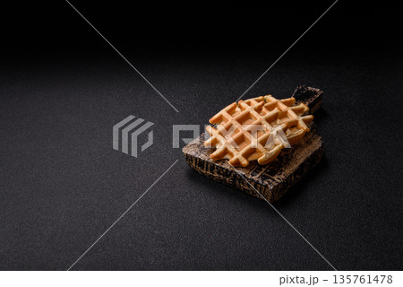 Belgian waffles, a healthy sweet breakfast dessert, food background. Belgian waffles Belgian waffles, a healthy sweet breakfast dessert, food background. Belgian waffles 135761478