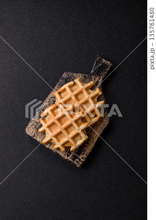 Belgian waffles, a healthy sweet breakfast dessert, food background. Belgian waffles 135761480