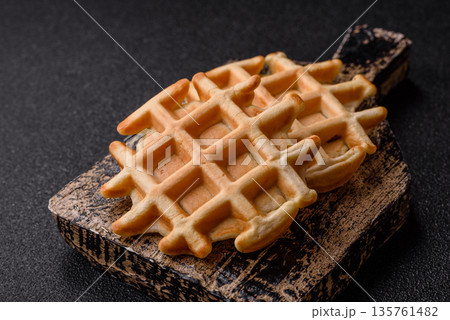 Belgian waffles, a healthy sweet breakfast dessert, food background. Belgian waffles 135761482