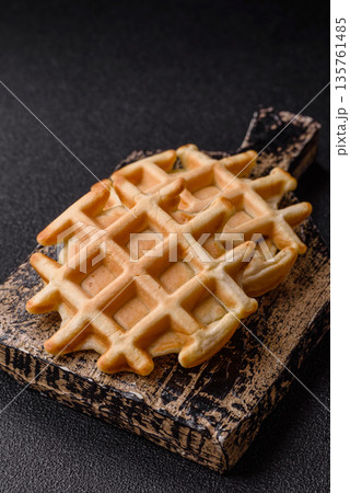 Belgian waffles, a healthy sweet breakfast dessert, food background. Belgian waffles Belgian waffles, a healthy sweet breakfast dessert, food background. Belgian waffles 135761485