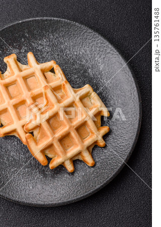 Belgian waffles, a healthy sweet breakfast dessert, food background. Belgian waffles Belgian waffles, a healthy sweet breakfast dessert, food background. Belgian waffles 135761488