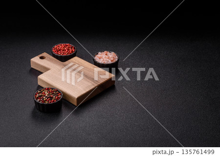 Wood, a wooden empty cutting board on a dark kitchen table. Wooden cutting board Wood, a wooden empty cutting board on a dark kitchen table. Wooden cutting board 135761499