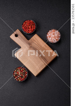 Wood, a wooden empty cutting board on a dark kitchen table. Wooden cutting board Wood, a wooden empty cutting board on a dark kitchen table. Wooden cutting board 135761501