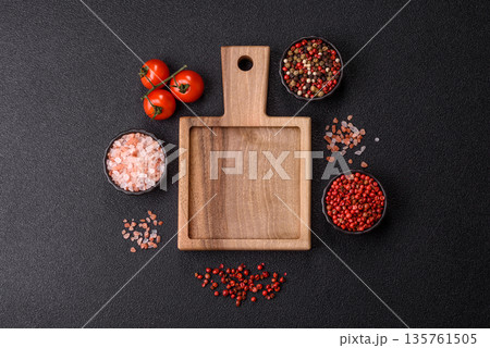 Wood, a wooden empty cutting board on a dark kitchen table. Wooden cutting board Wood, a wooden empty cutting board on a dark kitchen table. Wooden cutting board 135761505