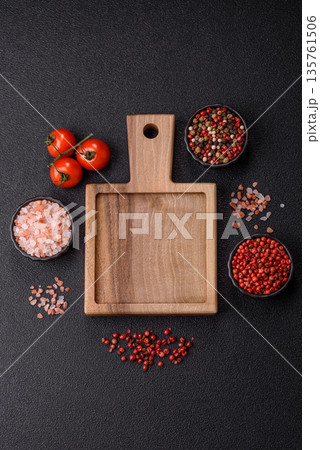 Wood, a wooden empty cutting board on a dark kitchen table. Wooden cutting board Wood, a wooden empty cutting board on a dark kitchen table. Wooden cutting board 135761506